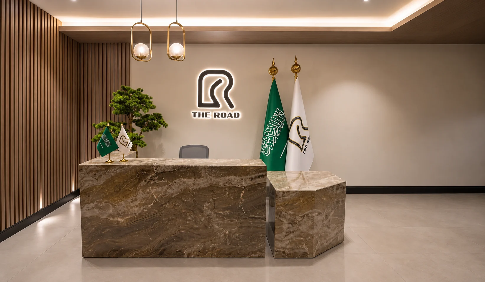 The Road office reception with the illuminated Road logo and Saudi and company flags